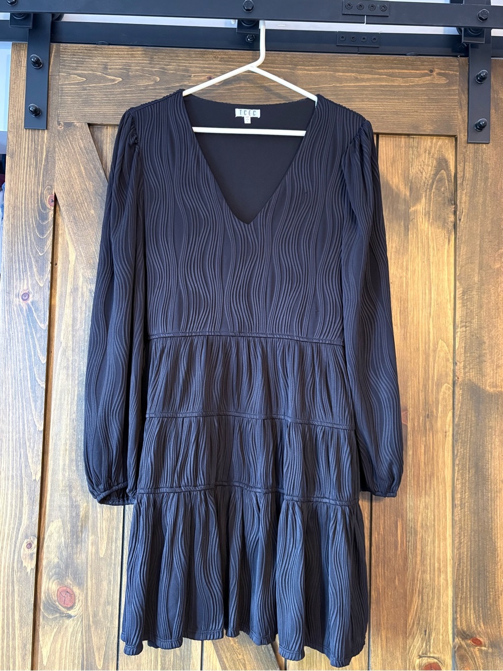 Black Long-Sleeve V-Neck Tiered Dress with textured wave pattern